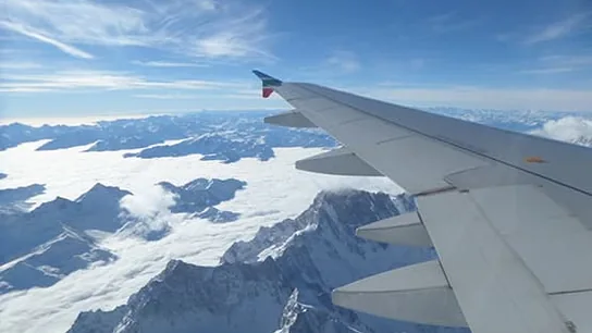 View of the snow-covered Alps from an airplane