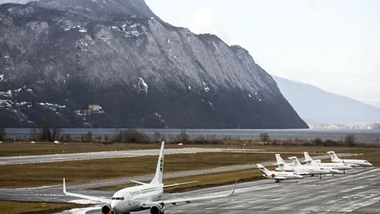 Plane on the tarmac with mountains near Chambéry