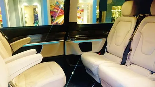 Light-colored individual armchairs in a van