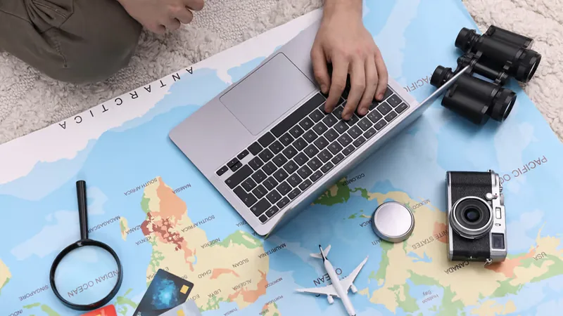 Preparing for a trip with a laptop and a map